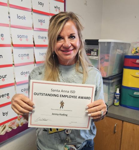 teacher holding outstanding employee award certificate